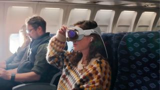 woman using apple vision pro on a plane