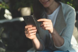 A woman using an Android phone.