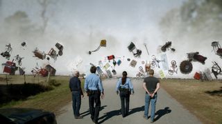 A scene from Under the Dome where all magnetic objects within the dome suddenly fly towards its perimeter as authorities look on in confusion.