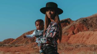 Ivan McClellan photograph of woman in cowboy hat with baby