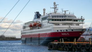 a white ship with a red band and a black lower portion.