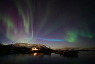 blue ribbon of light appearing over Abisko National Park, Sweden. 