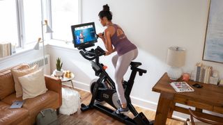 Woman exercising on a NordicTrack exercise bike at home