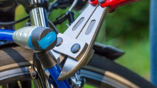 How to choose a virtually theft-proof bike lock: Pictured here, someone trying to cut a bike lock with a hand tool