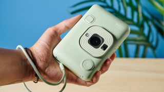 A matcha green Fujifilm Instax mini LiPlay 2-in-1 instant camera and printer