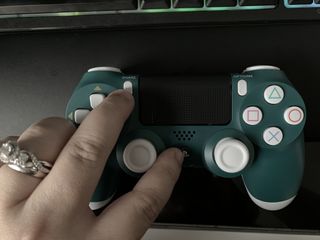 Pair DualShock 4 controller by showing steps: Hold down the Playstation and Share button for several seconds until the light flashes white