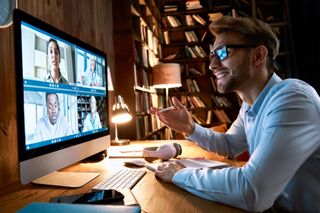 A person at a computer taking part in a virtual meeting.