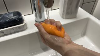 An image showing a person cleaning a Beautyblender