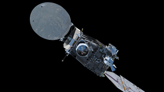 A spacecraft is seen with a metal box like shape in the middle and a white disk-like shape toward the left.