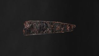 Side view of the blade of an 1,800-year-old iron knife with Danish runes that seem to spell out the word "hirila."