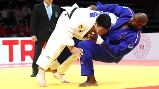 France's Teddy Riner (Blue R) fights against Japan's Tatsuru Saito (white) in the Men's +100kg Judo category in the build up to the 2024 Paris Olympic Games.