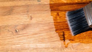 A wood surface being treated with wax