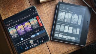 OnePlus Open and Amazon Kindle Oasis on table