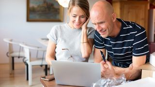 A couple opens a new laptop