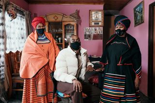 Portrait of designer Rich Mnisi with two beaders who collaborated on his collection