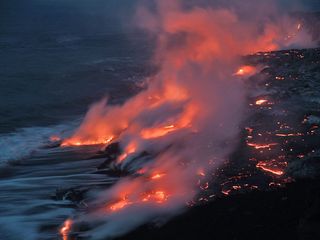 Hot magma deep within Earth may have heated carbon-rich rocks, releasing methane into the atmosphere and leading to an ancient warming event, scientists suggest. Here, lava from a 2004 Kilauea eruption flows into the sea.