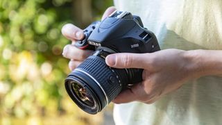 Nikon D3500, one of the best camera for beginners, being used by someone