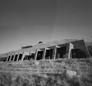 black and white photo of stone house in nature in south africa