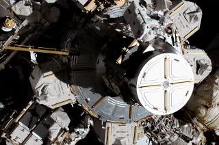 Jessica Meir (at top left, with back to camera) and Christina Koch begin the first all-female spacewalk outside the Quest airlock of the International Space Station on Friday, Oct. 18, 2019.