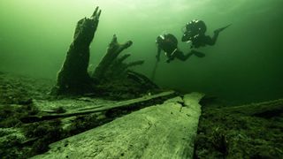 Maritime archaeologists Johan Rönnby (left) and Rolf Warming diving near the stern of the Gribshunden wreck. The ship sank in 1495 and was rediscovered in the 1970s. 