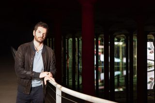 Portrait of artist Anri Sala with his installation, Time No Longer, 2021, in the Buffalo Bayou Park Cistern, Houston