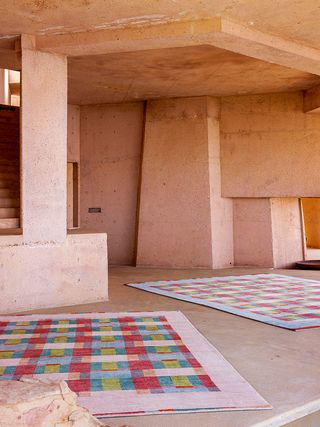 colourful rugs on a dusty floor