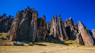 photo of towering stone features in peru called the Huayllay Stone Forest against a clear blue sky