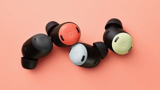 The Google Pixel Buds Pro in four colours on a pink background.