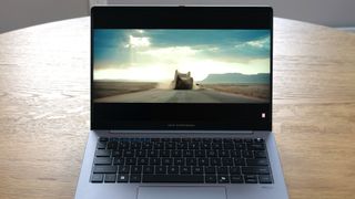 Asus ExpertBook P5 (P5405) open on a wooden table showing the trailer for Thunderbolts to demonstrate muted screen colors