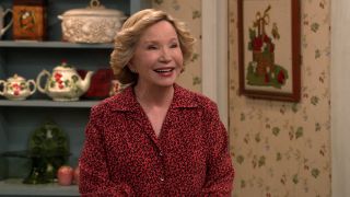 Debra Jo Rupp smiling in Foreman home's kitchen in That '90s Show