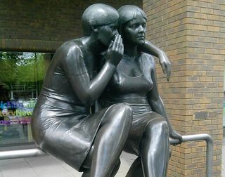 Two women whispering statue, gossip, secrets