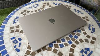 At home with 15-inch MacBook Air, on a mosaic balcony table and on a wooden floor.