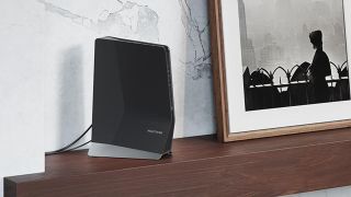 Netgear Nighthawk AX8 WiFi Mesh Extender (EAX80) on table in living room