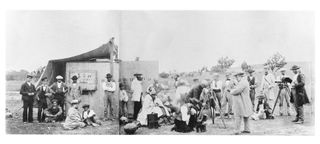 The lens of the telescope is just visible above its shelter. Warren De La Rue (1815-1889) a pioneer in astronomical photography, appears twice as this view was montaged from two separate photographs. The camp was established to observe an eclipse