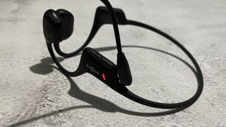 The Shokz OpenRun Pro bone conduction sports headphones in black pictured on a white surface.