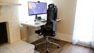 A standing desk next to a fireplace