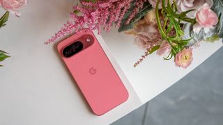 The Peony pink Google Pixel 9 next to some flowers