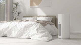 An air purifier standing in a bedroom