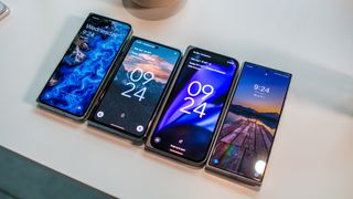 Pixel 9 Pro Fold next to Pixel Fold, OnePlus Open and Galaxy Z Fold 6 showing cover screens