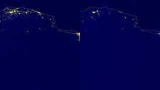 city lights shine yellowish-green against a black nighttime backdrop in this satellite image.