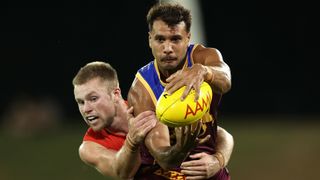 Callum Ah Chee of the Lions is tackled by Braeden Campbell of the Swans at the Sydney vs Brisbane live stream