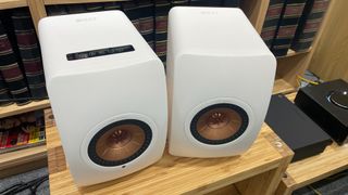 KEF LS50 Wireless II in white finish on wooden rack