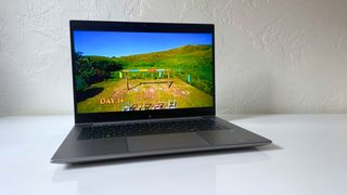 The HP ZBook Firefly 14 G11 playing an episode of Survivor (NBC) on a white table