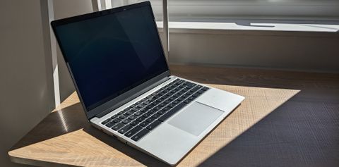 The Framework Laptop Chromebook Edition photographed on a wooden desk.