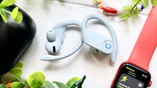 Listing image for the best Beats headphones showing the Beats Powerbeats Pro sitting next to an Apple Watch