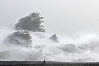 Waves crashed over Newhaven Harbor wall in Newhaven, southern England on Feb. 18, as Storm Eunice brought high winds across the country. Powerful storms such as this are becoming more frequent due to human induced climate change.