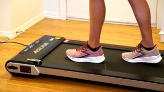 A photo of someone walking on the Sunny Health and Fitness Treadpad