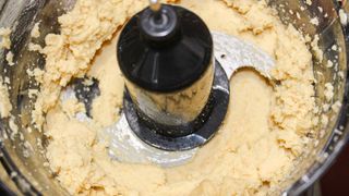 Crux 8 Cup Food Processor processing onions hummus