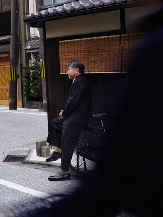 Japanese director Hirokazu Kore-eda on the street in Tokyo wearing John Lobb shoes