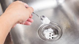 Pouring baking soda down drain